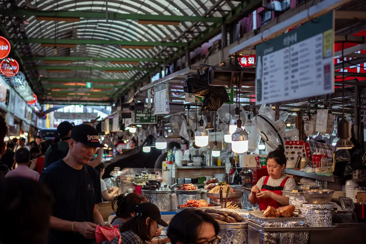 Shoppers moving between vendor stalls inside a covered market hall